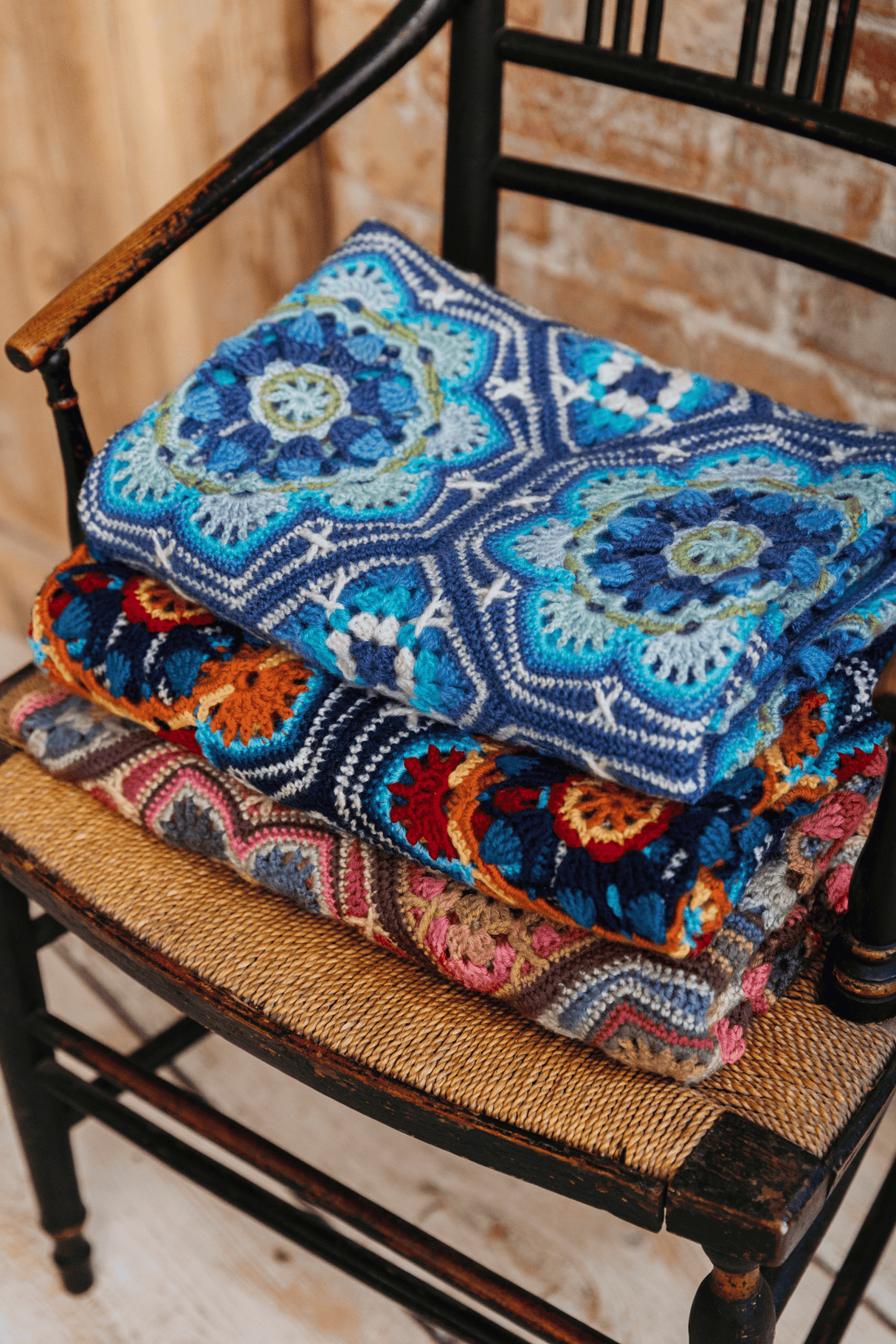 Janie Crow's Persian Tiles Trow Crochet Afghan in Sandlewood Dark Blue and Light Blue on rocking chair